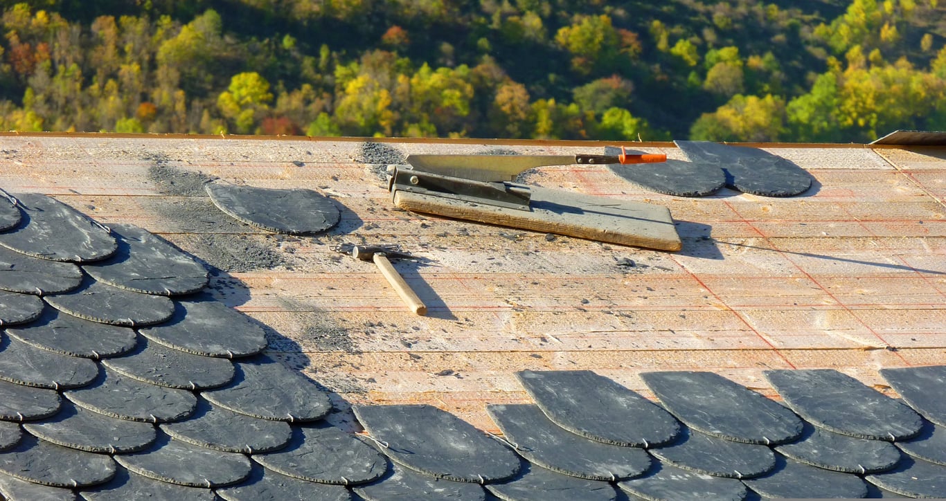 roofer inspecting roof flashing